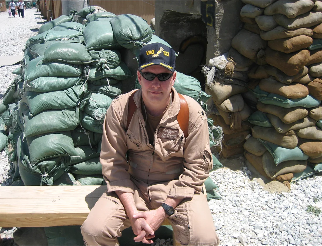 J.P. Springett II in service uniform near sandbags
